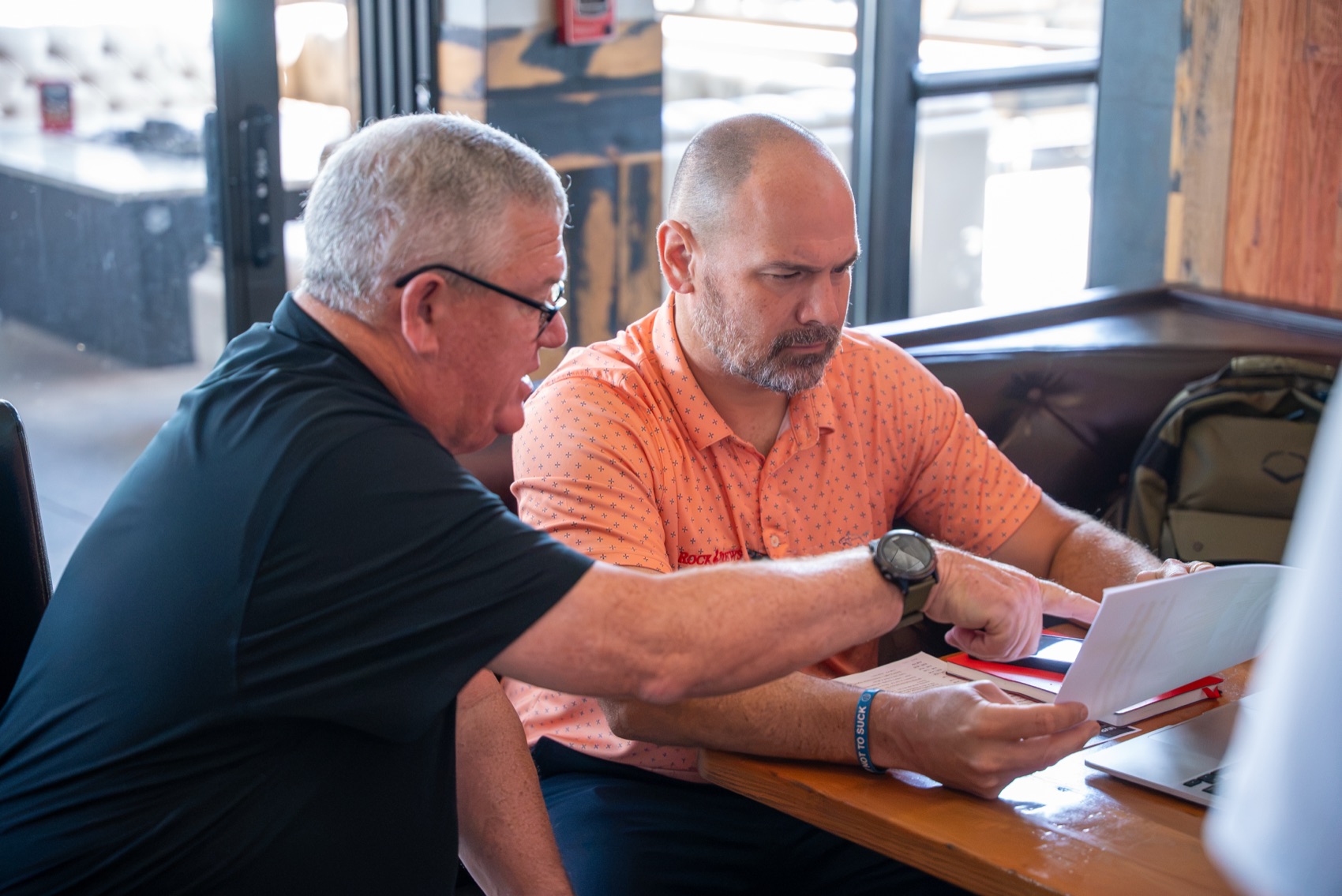 Dave Duff working through invoices with Kris Maronpot at Rock & Brews